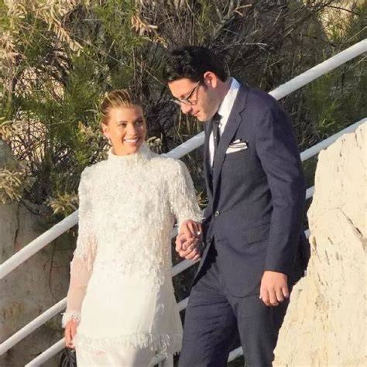 Blushing bride Sofia Richie looks radiant in an elegant white gown as she celebrates her lavish wedding weekend in the French Riviera. The model and daughter of legendary crooner Lionel Richie stepped out with her British fiance Elliot Grainge on Friday evening during their ultra glamorous trip to tie the knot in Antibes. It was unclear whether the happy couple were heading off to a fancy rehearsal dinner, or were dressed up for the nuptials. The stylish 24-year-old chose a demure, delicately beaded floor length ensemble for the occasion paired with white stilettos and wore her long hair in a chic up do. Her record executive groom, 30, looked dapper in a dark suit and tie as they were snapped by their team of photographers at their swanky hotel at sunset. Among the slew of A-list guests jetting in to watch them exchange vows are Cameron Diaz and Benji Madden, Sofia&rsquo;s sister Nicole Richie and husband Joel Madden, as well as her father Lionel Richie and brother Miles. 21 Apr 2023 Pictured: Sofia Richie , Elliot Grainge. Photo credit: EliotPress / MEGA TheMegaAgency.com +1 888 505 6342 (Mega Agency TagID: MEGA971732_027.jpg) [Photo via Mega Agency]