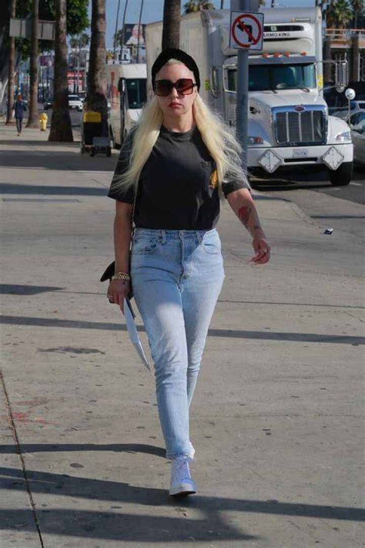 EXCLUSIVE: Amanda Bynes runs errands in Los Angeles on the heels of news that she has rekindled her romance with her ex-fiance Paul Michael. The former child TV actress, who is now studying to become a manicurist, stopped by a 7-11 for a quick coffee and then headed to CVS for a few essentials. The heart tattoo on her left cheek, which she has been in the process of having removed, was still visible and she sported long white nails, vaping as she walked. Bynes, 36, accessorized with large gold earrings which appeared to be Christian Dior designer brand, and a nose ring. 24 Oct 2022 Pictured: Amanda Bynes. Photo credit: Snorlax / MEGA TheMegaAgency.com +1 888 505 6342 (Mega Agency TagID: MEGA910952_007.jpg) [Photo via Mega Agency]
