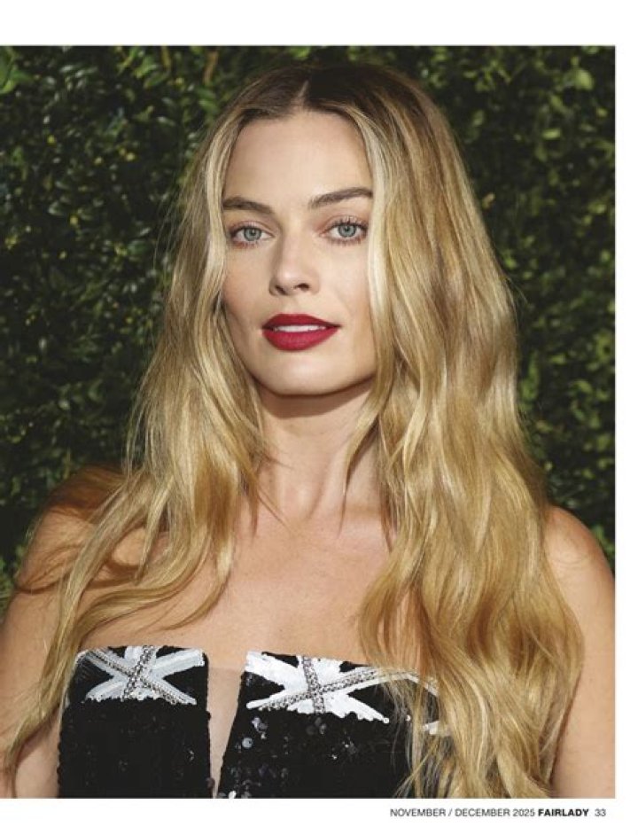 Margot Robbie in a black mini dress